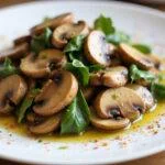 Final dish of sautéed button mushrooms presented elegantly, showcasing the delicious use of champignon mushrooms in a delightful culinary creation.