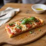 Enjoying a slice of Greeks' Neighborhood Pizza Paradise, a delectable Greek pizza made to satisfy cravings for pizza near you.