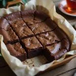 Deliciously baked lactation brownies displayed on a wooden table, perfect for nursing mothers.