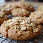 Perfectly baked oatmeal protein cookies cooling on a rack, ideal for a healthy snack or energy boost.