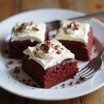 Deliciously plated red velvet brownies with cream cheese frosting, showcasing the final result of this enticing red velvet brownie recipe.