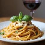 Delicious plate of al dente spaghetti, garnished with basil and parmesan, representing the ultimate tipos de pasta perfection.